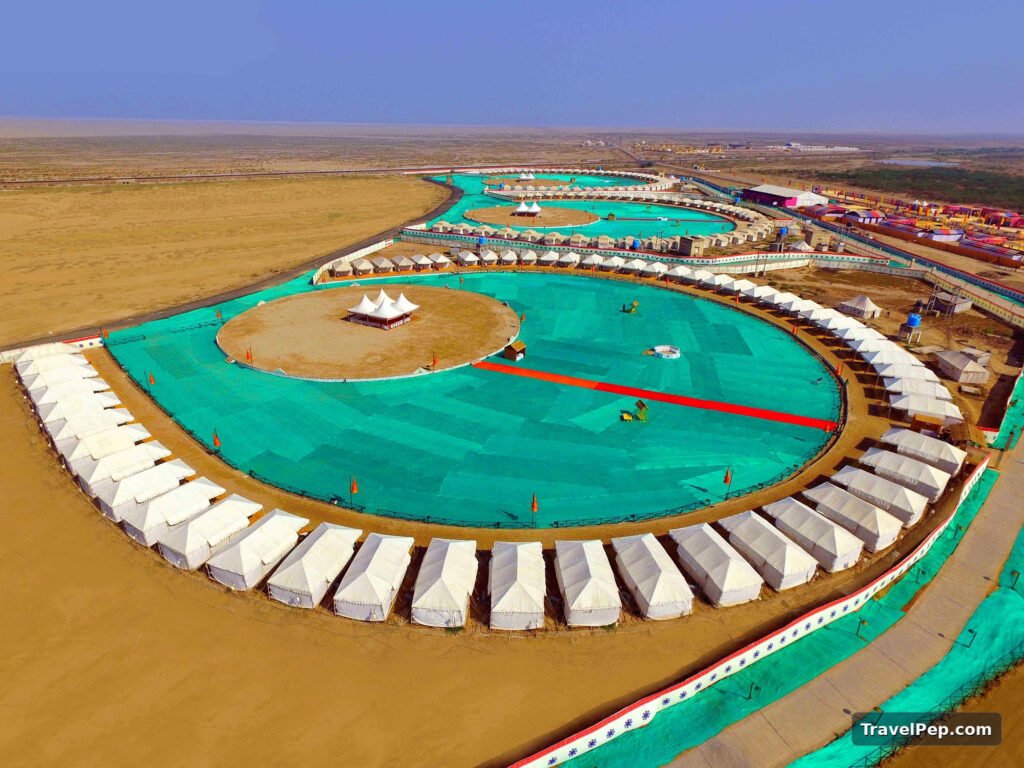 Rann Utsav 2026-27 at Dhordo: Dates, Tent City, Permit, and the Best Nights to Go 18 Aerial view of the Rann Utsav Tent City at Dhordo, rows of tents around open lawns
